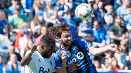 Montreal Impact midfielder Marco Donadel, right, heads the ball away from Vancouver Whitecaps' Tony Tchani during the first half in Montreal on Saturday. The Whitecaps scored in the 80th minute to earn a 2-1 win. whitecaps-impact-042917-620