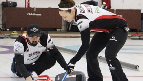 Reid Carruthers throws as Joanne Courtney sweeps at a previous mixed doubles curling event. n this handout photo. carruthers-courtney
