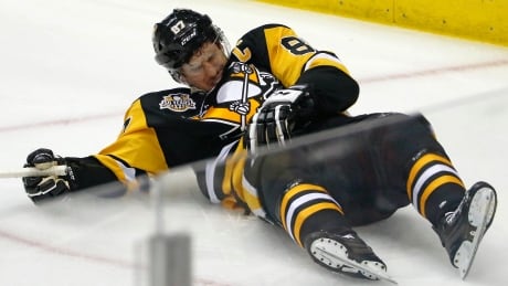 Pittsburgh Penguins' Sidney Crosby (87) lies on the ice after taking a hit from Washington Capitals' Matt Niskanen during the first period of Game 3 on Monday. crosby-sidney