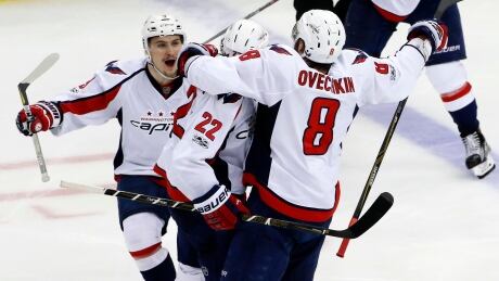 Washington Capitals' Kevin Shattenkirk (22) celebrates with Dmitry Orlov (9), and Alex Ovechkin (8) after scoring in overtime Monday to give the Capitals a 3-2 win. capitals-penguins