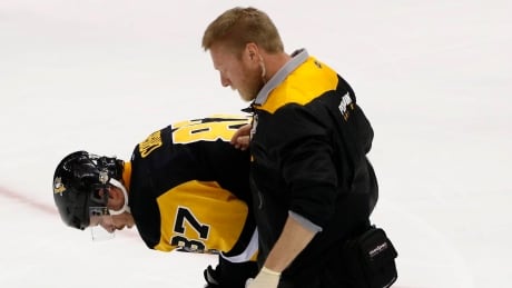 Pittsburgh Penguins' Sidney Crosby (87) is helped off the ice after being injured during the first period of Game 3 in an NHL Stanley Cup Eastern Conference semifinal hockey game against the Washington Capitals in Pittsburgh, Monday, May 1, 2017. (AP Photo/Gene J. Puskar) Capitals Penguins Hockey