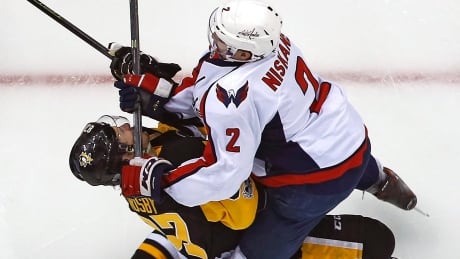 Pittsburgh's Sidney Crosby takes a stick to the head from Washington's Matt Niskanen during Game 3 on Monday. APTOPIX Capitals Penguins Hockey