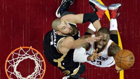 Cleveland's LeBron James fights to the basket against Toronto's Jonas Valanciunas during the Cavaliers' 125-103 win in Game 2 Wednesday. Raptors Cavaliers Basketball