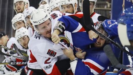 Ottawa's Dion Phaneuf fights New York's Brendan Smith late in the Rangers' 4-1 win Thursday. 95642726