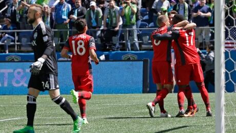 Toronto FC forward Jozy Altidore is greeted by teammates after scoring on a penalty kick in the first half against the Seattle Sounders on Saturday in Seattle. Toronto won 1-0. toronto-fc-seatle-sounders-050617-620