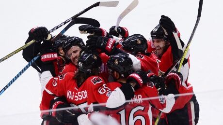 The Ottawa Senators celebrate after scoring against the New York Rangers late in the game during the third period. rangers-senators