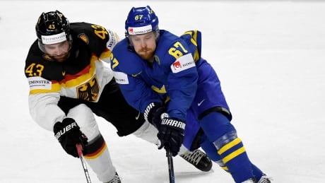 Germany's Gerrit Fauser, left, and Sweden's Linus Omark vie for the puck during the hockey worlds on Saturday. Germany Hockey Worlds