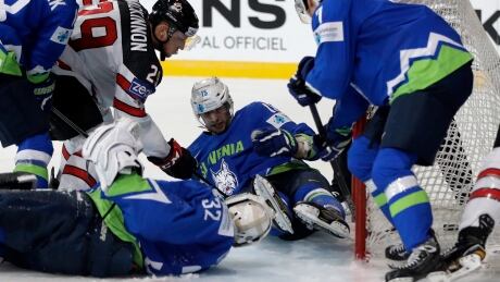 Canada's Nate Mackinnon, top left, scores a goal against Slovenia during the hockey worlds in Paris on Sunday. France Hockey Worlds