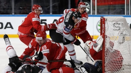 Canada's Nate Mackinnon, centre, scores past Belarus' Mikhail Karnaukhov in a Group B match at the hockey world championships in Paris on Monday. canada-belarus-hockey-worlds-050817-620