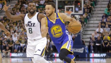 Golden State Warriors guard Stephen Curry (30) drives as Utah Jazz guard Shelvin Mack (8) defends in the first half during Game . warriors-jazz
