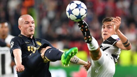 Monaco's Andrea Raggi, left, fights for the ball with Juventus' Paulo Dybala during Juventus' 2-1 win that advanced it to the Champions League final. AFP_O92F8