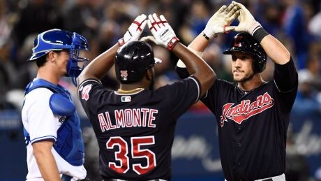 Cleveland Indians catcher Yan Gomes (7) is congratulated by Indians right fielder Abraham Almonte (35) after hitting a three-run home run against the Toronto Blue Jays. indians-blue-jays