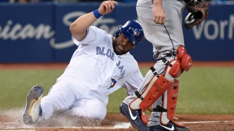 Toronto Blue Jays designated hitter Kendrys Morales, left, scores against the Cleveland Indians during third inning in Toronto on Monday. He will miss Wednesday's game with a hamstring strain. indians-jays