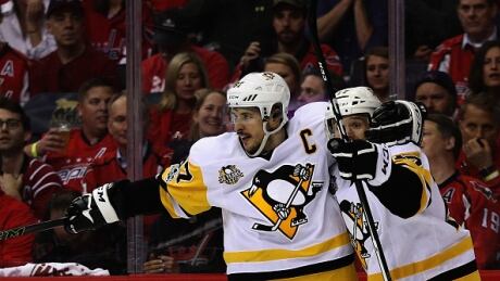 Pittsburgh Penguins' Bryan Rust celebrates with Sidney Crosby after scoring a second period goal against the Washington Capitals in Game 7. penguins-capitals