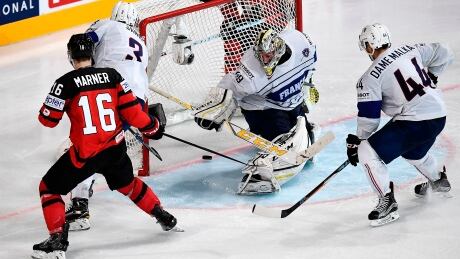 Mitch Marner watches the puck go past French goaltender Florian Hardy during Canada's 3-2 win Thursday at the world championships in Paris, France. AFP_OB61W