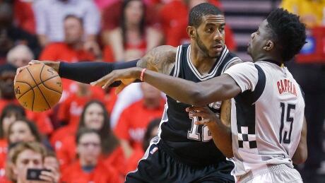 San Antonio Spurs forward LaMarcus Aldridge, left, is defended by Houston Rockets centre Clint Capela during the first half in Game 6 on Thursday in Houston. spurs-rockets-051117-620
