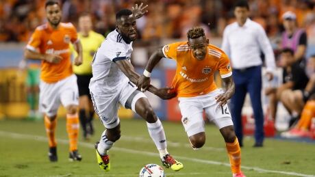 Romell Quioto, right, picked up an assist in the Houston Dynamo's 2-1 victory over the Vancouver Whitecaps on Friday evening. vancouver-whitecaps