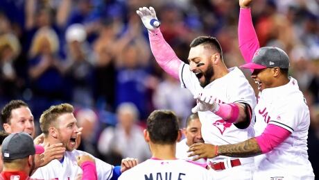 Toronto Blue Jays outfielder Kevin Pillar celebrates his game-winning home run against the Seattle Mariners with teammates during the ninth inning in Toronto on Sunday. blue-jays-051417-620