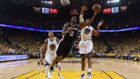 Kawhi Leonard, centre, sprained his left ankle in the third quarter of Sunday's game and did not return. kawhi-leonard