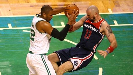 Boston's Al Horford bowls over Washington's Marcin Gortat during the Celtics' 115-105 win in Game 7 of their second-round series. 95806731