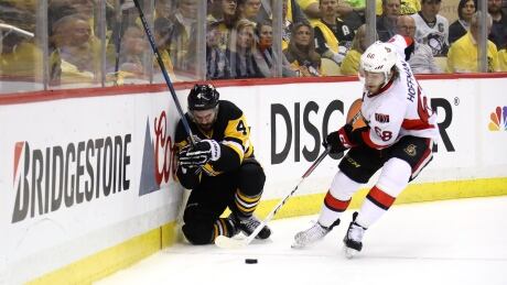 Pittsburgh blue-liner Justin Schultz, left, kneels on the ice in pain after being checked by the Senators' Mike Hoffman during the first period in Game 2 of the Eastern Conference final. The Penguins are attempting to win the Stanley Cup without a No. 1 defenceman. schultz-justin-051617
