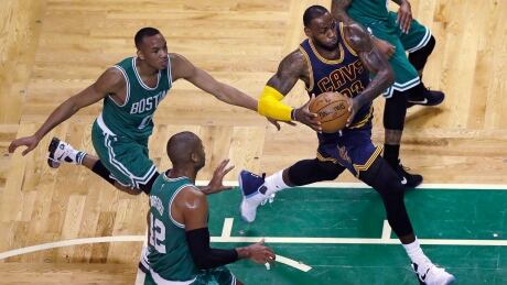 Cleveland Cavaliers forward LeBron James (23) drives to the basket past Boston Celtics guard Avery Bradley, left, and centre Al Horford (42) during the first quarter of a game in Boston earlier this year. cavaliers-celtics