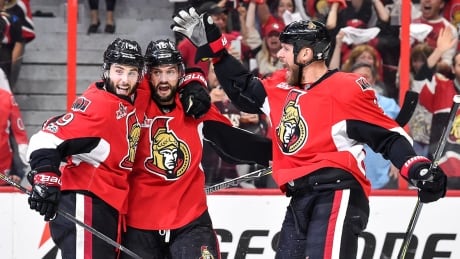 OTTAWA, ON - MAY 17: Derick Brassard #19 of the Ottawa Senators celebrates a first period goal with teammates Clarke MacArthur #16 and Marc Methot #3 against the Pittsburgh Penguins in Game Three of the Eastern Conference Final during the 2017 NHL Stanley Cup Playoffs at Canadian Tire Centre on May 17, 2017 in Ottawa, Ontario, Canada. The Ottawa Senators defeated the Pittsburgh Penguins 5-1. (Photo by Minas Panagiotakis/Getty Images) senators-celebrate-170517-1180
