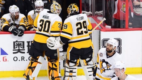 Pittsburgh Penguins goalie Marc-Andre Fleury (29) has a word with goalie Matt Murray (30) after being pulled during the first period of Game 3 of the Eastern Conference final against the Ottawa Senators in Ottawa on Wednesday. The Senators won 5-1 and hold a 2-1 lead in the series. penguins-fleury-murray-051717-620