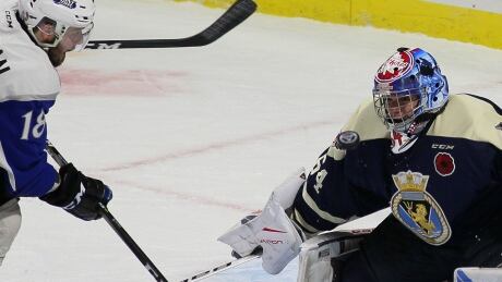 Windsor Spitfires goalie Michael DiPietro stops Saint John Sea Dogs' Spencer Smallman during the opening game Friday of the Memorial Cup tournament in Windsor, Ont. HKO Memorial Cup 20170519