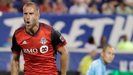 Toronto FC midfielder Benoit Cheyrou, left, celebrates his tying goal as TFC battled to a 1-1 draw with the New York Red Bulls on Friday. benoit-cheyrou