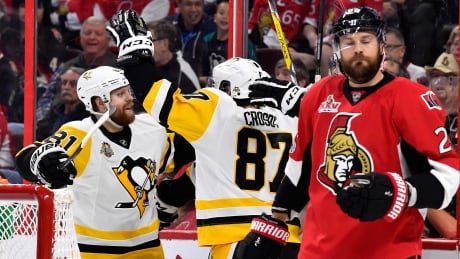 Sidney Crosby, centre, celebrates with Phil Kessel, left, after scoring against the Ottawa Senators on Friday evening. sidney-crosby