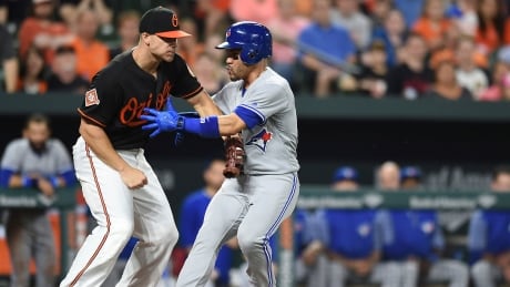 Toronto Blue Jays' Devon Travis is tagged out by Baltimore Orioles first baseman Chris Davis on Friday. The Orioles edged the Blue Jays 5-3 in extra innings. Travis-Devon-05192017