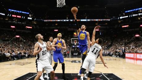 Golden State's Steph Curry drives to the basket against Bryn Forbes of the San Antonio Spurs during the Warriors' 129-115 win Monday to advance to the NBA Finals. warriors-spurs