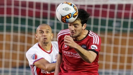 Ottawa Fury's Tucker Hume wins the battle for the ball over Toronto FC's Jason Hernandez during the Fury's 2-1 win in their Canadian championship semifinal. toronto-ottawa