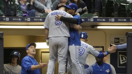 Toronto Blue Jays' Kendrys Morales is congratulated after hitting a two-run home run during the fifth inning against the Milwaukee Brewers. blue-jays-brewers