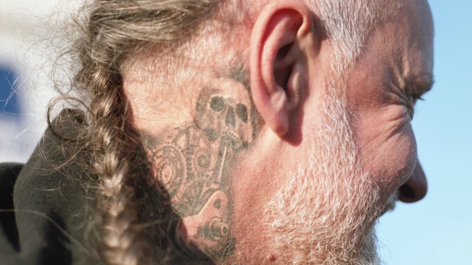 A member of the bike club Future Dead shows off his tattoo.