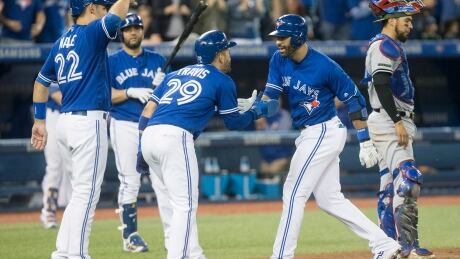 Toronto Blue Jays right-fielder Jose Bautista celebrates with teammates after hitting a three-run home run against the Texas Rangers in the fifth inning in Toronto on Saturday. blue-jays-052717-620