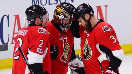 Ottawa Senators defenceman Dion Phaneuf (2), Senators goalie Craig Anderson (41) and Ottawa Senators defenceman Marc Methot (3) celebrate after winning Game 6 of the Eastern Conference final. ottawa-senators