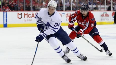Toronto Maple Leafs' Auston Matthews moves the puck in front of Evgeny Kuznetsov of the Washington Capitals in Game 5 of their first-round playoff series. The teams will reportedly face off in an outdoor game next season. caps-leafs