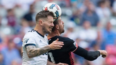 Vancouver Whitecaps' Tim Parker, left, battles for the ball with D.C. United's Sebastien Le Toux on Saturday. United held on for a 1-0 victory in Vancouver. Parker-Tim-05272017