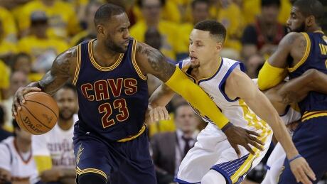 Cleveland Cavaliers forward LeBron James (23) dribbles against Golden State Warriors guard Stephen Curry during the first half of Game 1 of the 2016 NBA Finals in Oakland, Calif. cavaliers-warriors