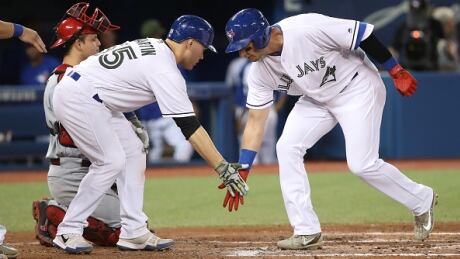 Troy Tulowitzki goes for a low-five with Russell Martin after hitting a grand slam in the third inning of Monday night's game against the Cincinnati Reds. tulowitzski-troy-052917