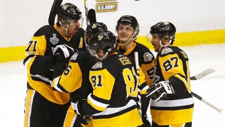 Pittsburgh's Evgeni Malkin (71) celebrates with teammates after scoring in the first period of the Penguins' 5-3 win over Nashville in Game 1 of the Stanley Cup final. penguins-predators