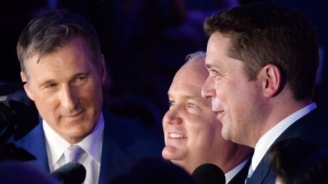 Candidates Maxime Bernier, left to right, Erin O'Toole and Andrew Scheer speak to reporters following the 12th ballot at the federal Conservative leadership convention in Toronto on Saturday, May 27, 2017. Conservative Convention 20170527