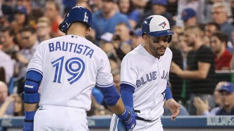 Jose Bautista, left, and Devon Travis, right, each bounced back from a brutal April to help lead the Blue Jays to an 18-10 month of May. bautista-jose-travis-devon-060117