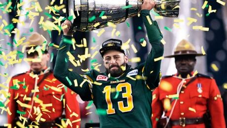 Edmonton Eskimos quarterback Mike Reilly hoists the Grey Cup after his teams win over the Ottawa in 2015. Edmonton Eskimos quarterback Mike Reilly