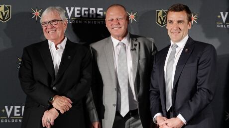 In this April 2017 file photo, Vegas Golden Knights coach Gerard Gallant is flanked by team owner Bill Foley, left, and George McPhee, team general manager, in Las Vegas. McPhee says his team anticipates making trades sometime next week. Draft Lottery Hockey