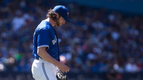 Toronto Blue Jays relief pitcher Jason Grilli walks back to the mound after giving up a home run to New York Yankees second baseman Starlin Castro during the eighth inning in Toronto on Saturday. grilli-jason-060317-620