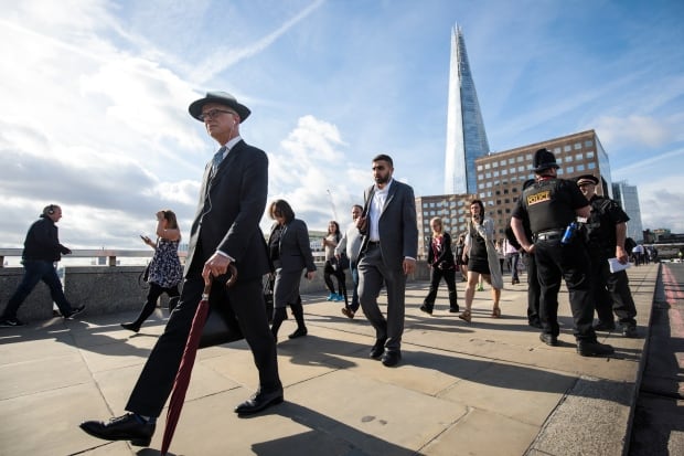 Commuters cross London Bridge following terror attack