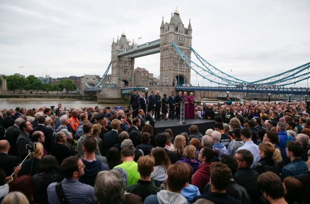 People gather for a vigil in Potters Fields Park in London